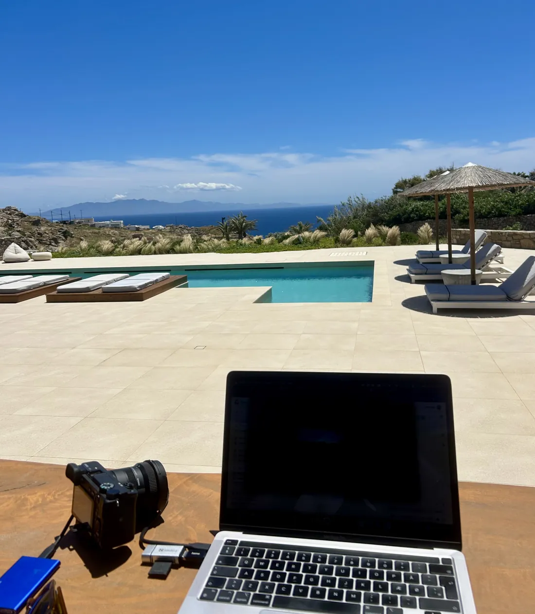Camera and laptop at the poolside on Mykonos